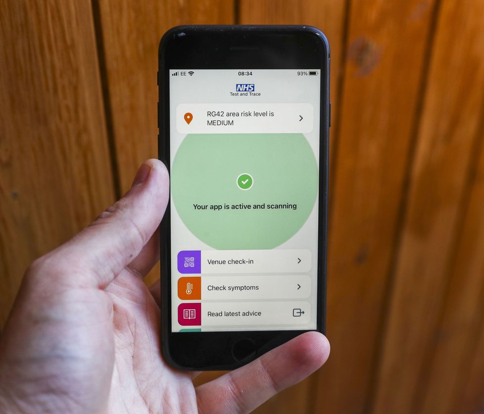 A phone with the Covid-19 NHS app open