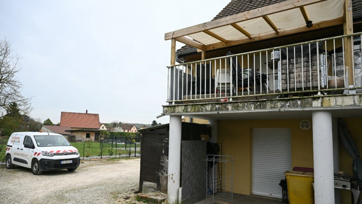 A photo shows a residential building, with the involved suspects' terrace at the first level (R), and parking area at the location where a boy was discovered naked and malnourished on a pile of rubbish in a van where he had been kept locked up, in Hagenbach, eastern France, on April 10, 2026