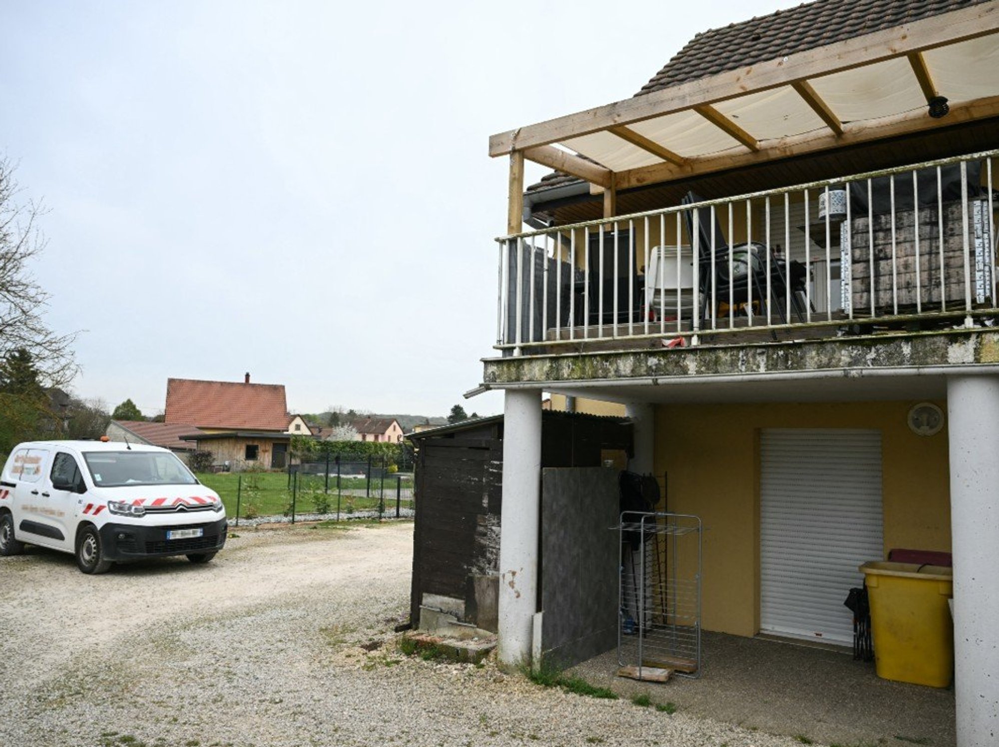 A photo shows a residential building, with the involved suspects' terrace at the first level (R), and parking area at the location where a boy was discovered naked and malnourished on a pile of rubbish in a van where he had been kept locked up, in Hagenbach, eastern France, on April 10, 2026