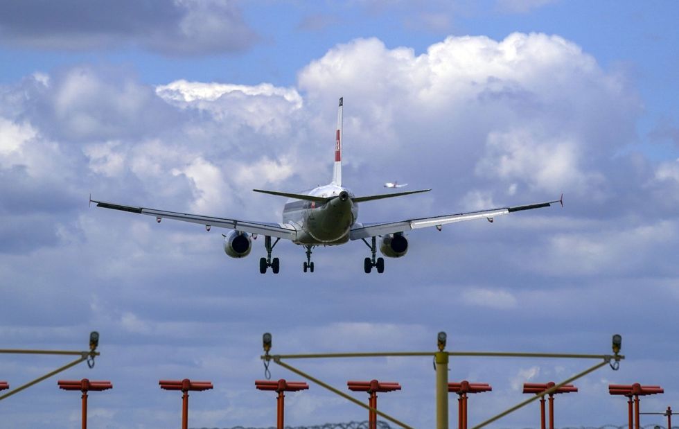 A plane lands on the southern runway at London Heathrow Airport. US and EU travellers who are fully vaccinated against coronavirus will be allowed to enter England and Scotland without the need to quarantine from Monday. Travellers will be required to take a pre-departure test, and a PCR test on or before the second day after their arrival. Picture date: Thursday July 29, 2021.