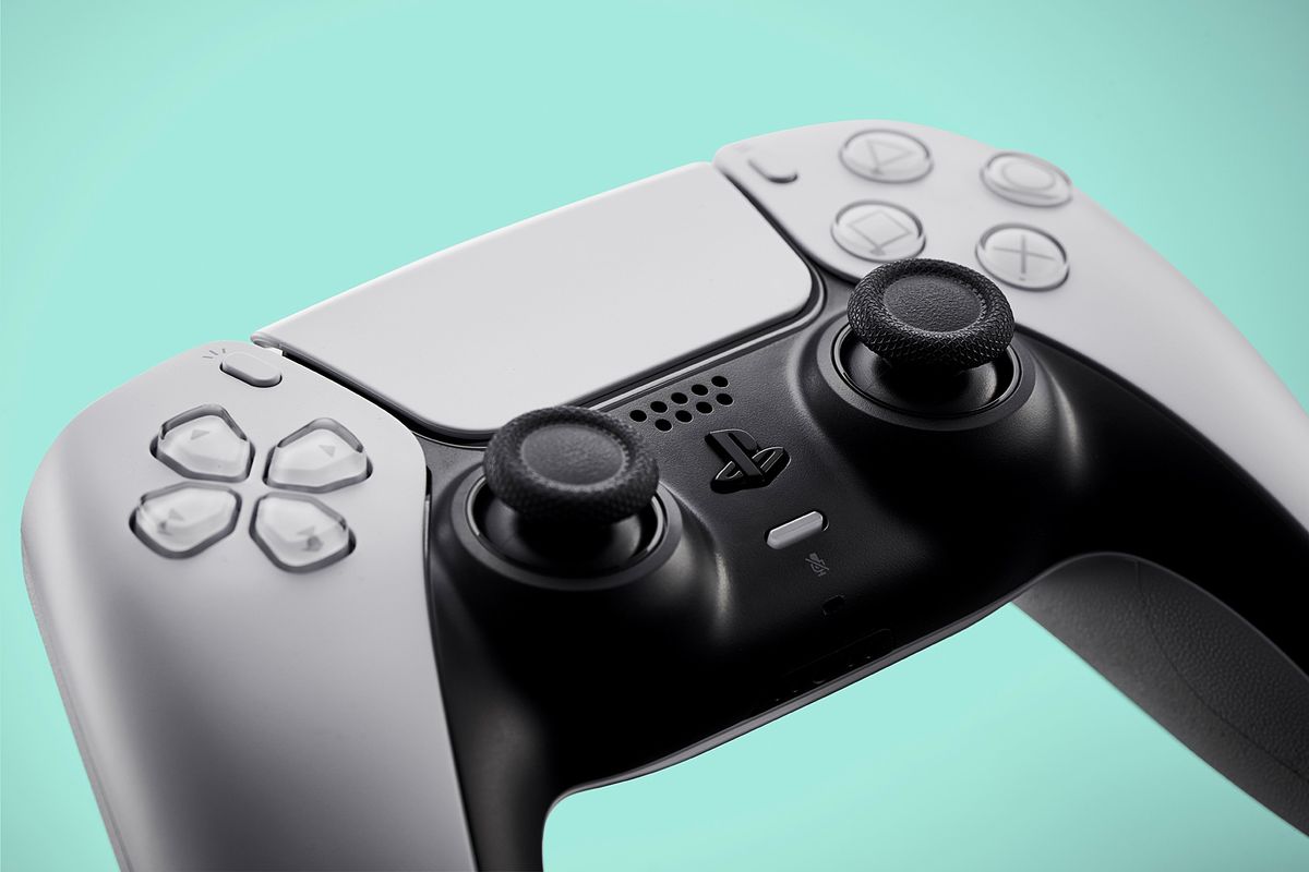 a playstation 5 controller pictured against a teal background  