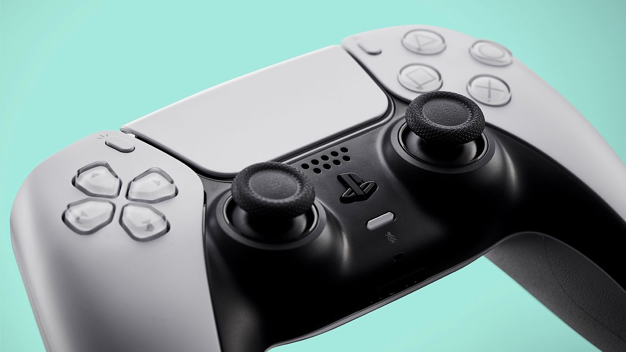 a playstation 5 controller pictured against a teal background