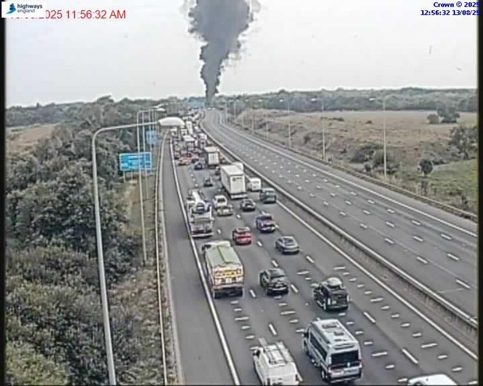 A plume of smoke from the fire can be seen along the M25