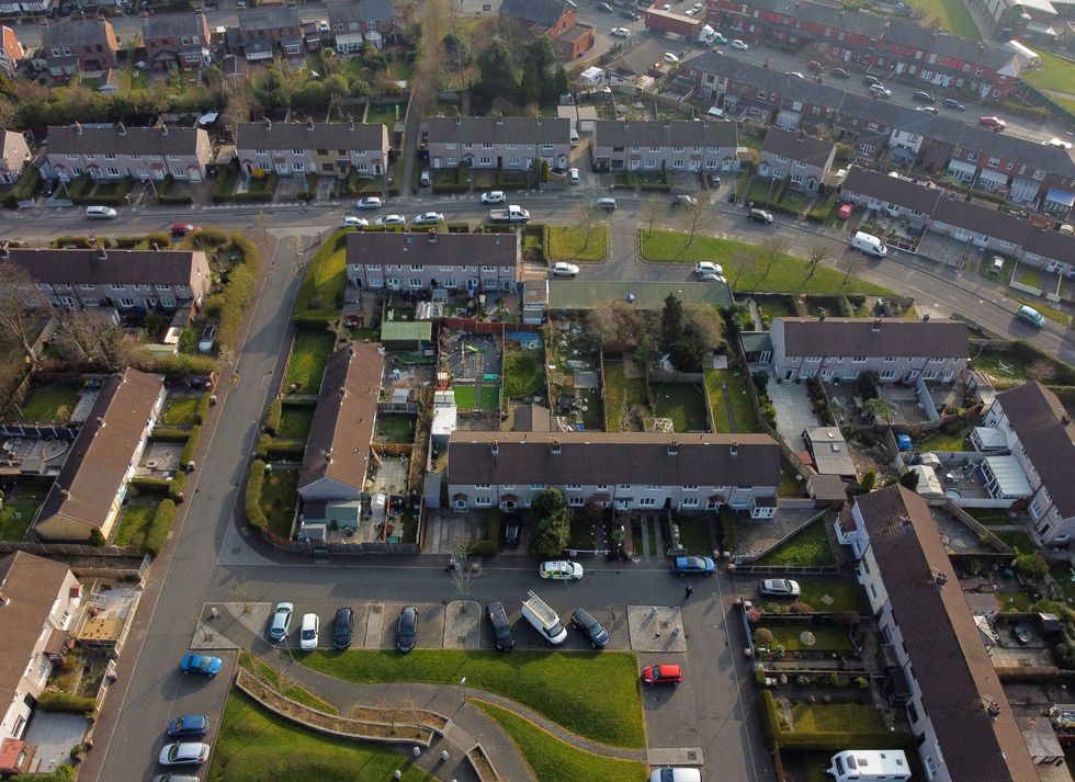 A police car (bottom centre) outside a house in St Helens after a 17-month-old girl died after being attacked by a dog. Merseyside Police said officers received a report at 3.50pm on Monday that a child had been attacked by a dog at an address on Bidston Avenue, Blackbrook. Picture date: Tuesday March 22, 2022.