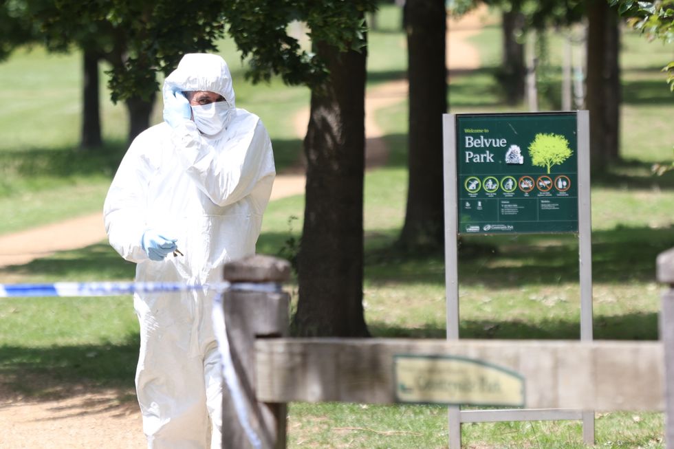 A Police forensic officer at the scene where a body was found after a fire in the early hours of this morning in Belvue Park, west London.
