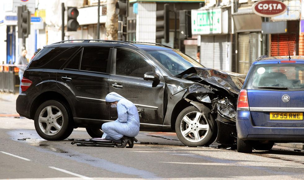 A police forensics officer attends the scene in Bethnal Green Road, east London