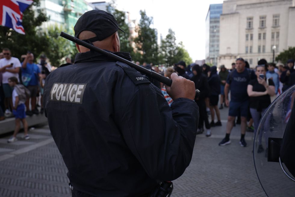 A police officer faces protesters in Liverpool\u200b