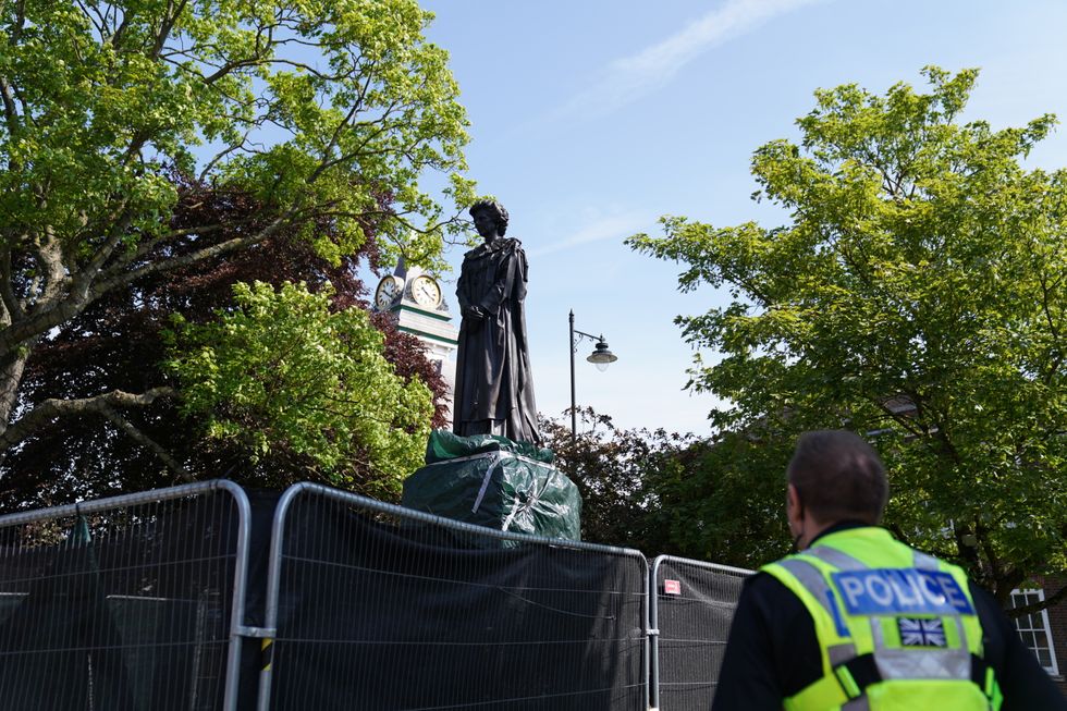A police officer looks at the newly installed statue of Baroness Margaret Thatcher in her home town of Grantham, Lincolnshire. Picture date: Sunday May 15, 2022.