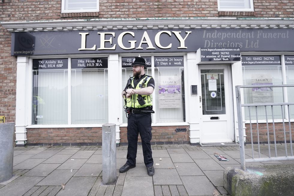 A police officer stood outside the funeral parlour