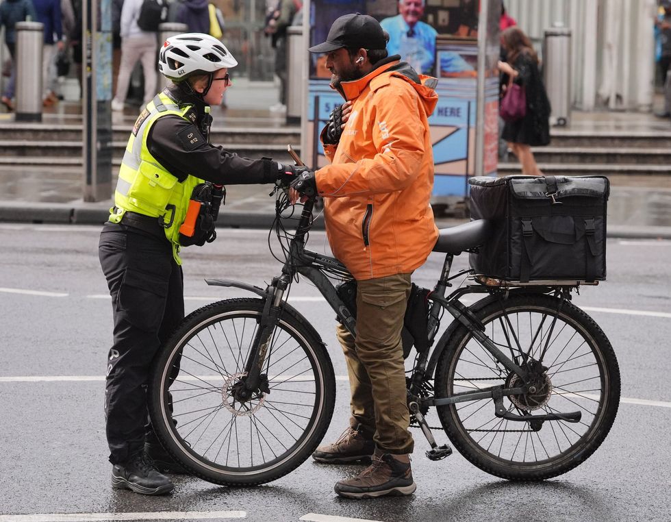 A police officer stopping an electric bike