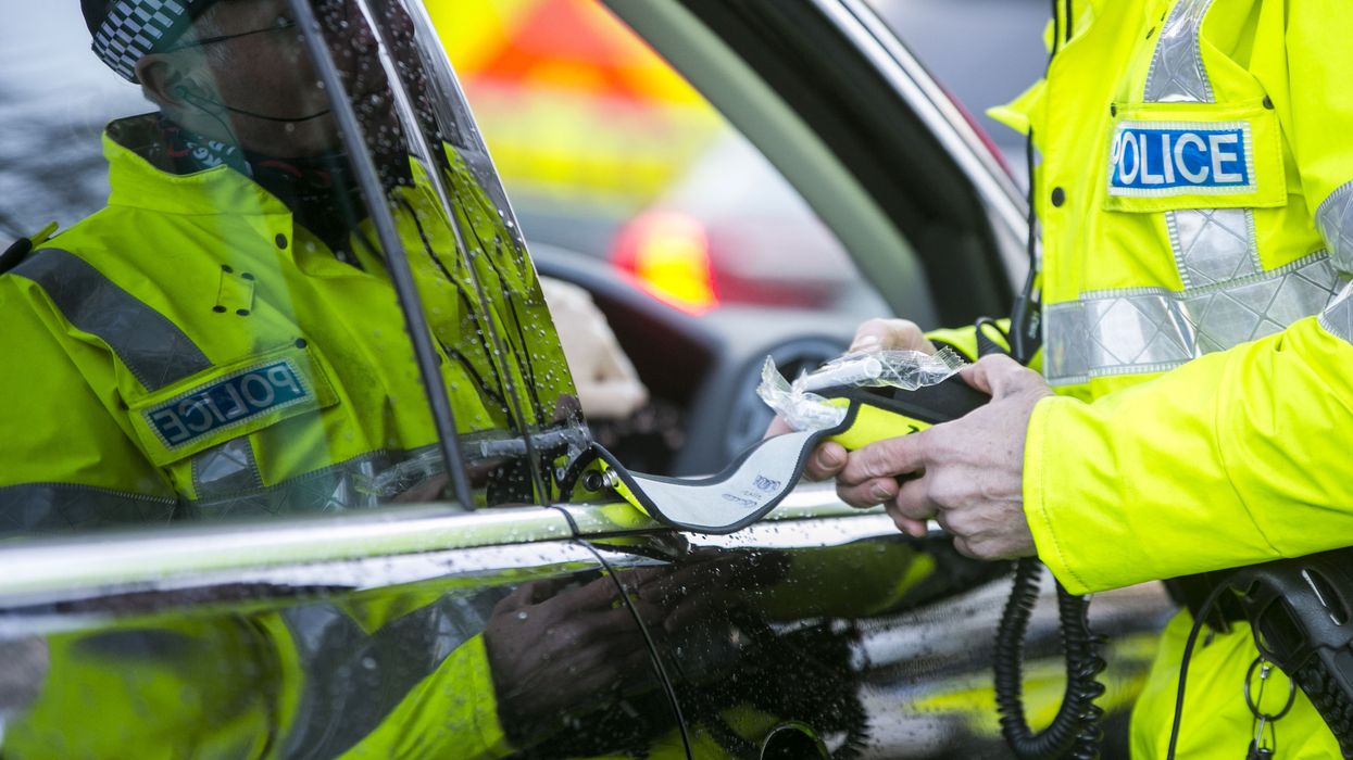 A police officer with a breathalyser