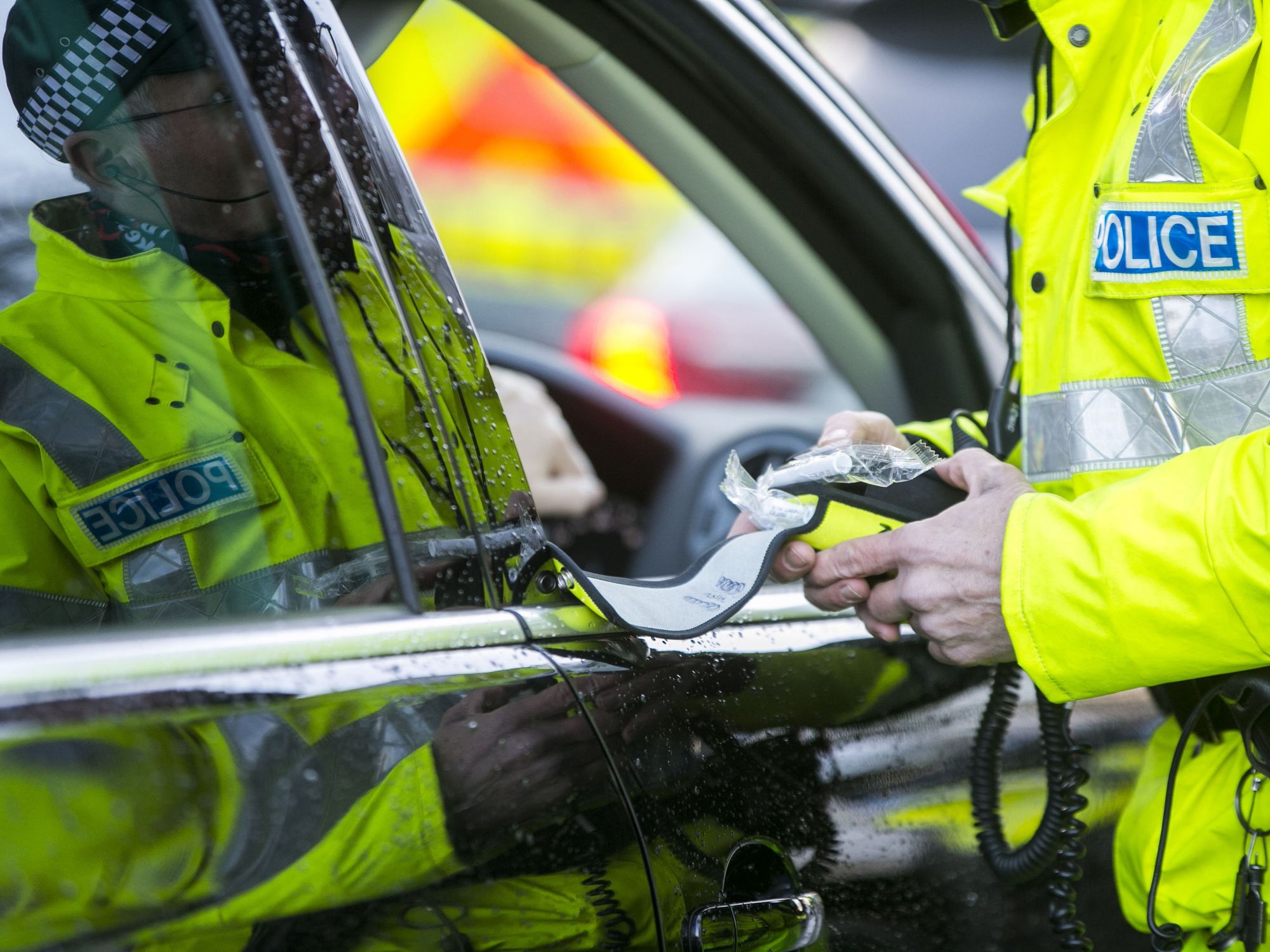 A police officer with a breathalyser