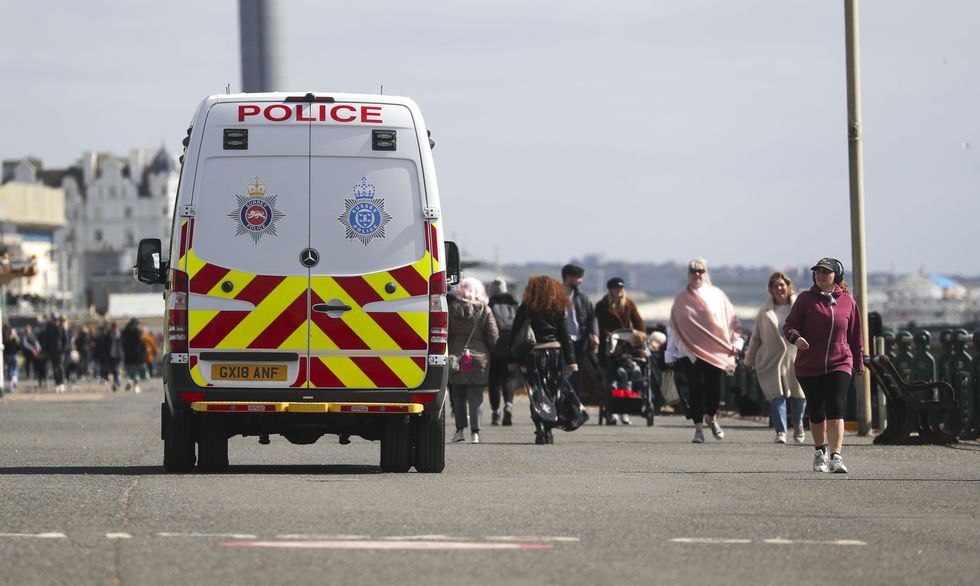 A police van patrols on the promenade next to Brighton beach, East Sussex. Picture date: Friday April 2, 2021.
