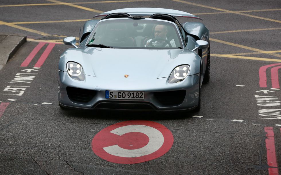 A Porsche driving over the Congestion Charge logo