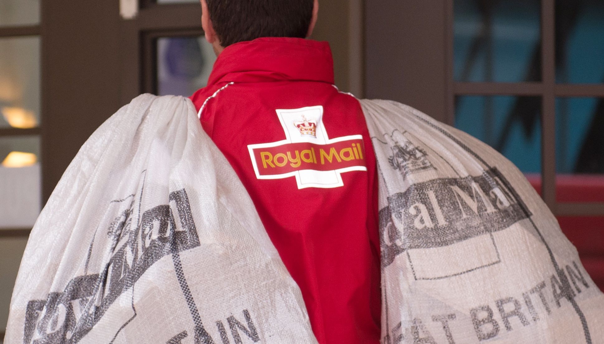 A postman carries bags of mail into Blackfriars Crown Court, London.