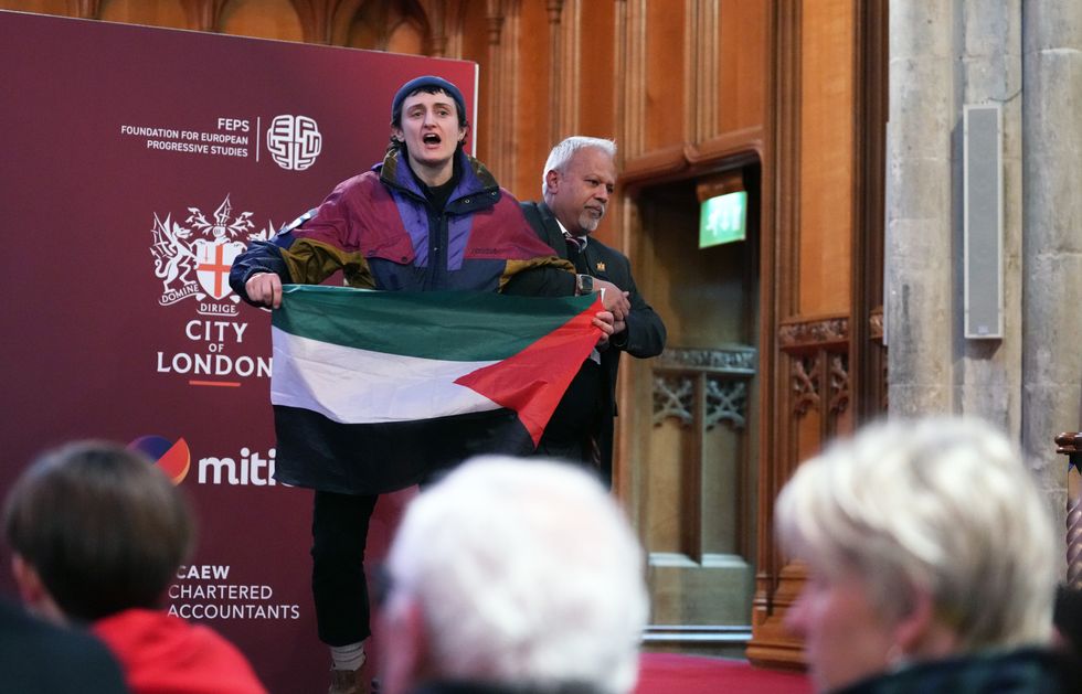 A pro-Palestinian protester is removed from the room after interrupting shadow foreign secretary David Lammy during his speech to the Fabian Society conference in central London