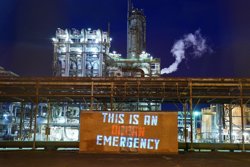 A projection at the Grangemouth Oil Refinery in Falkirk, by climate activists from Ocean Rebellion, during Cop26 in Glasgow.