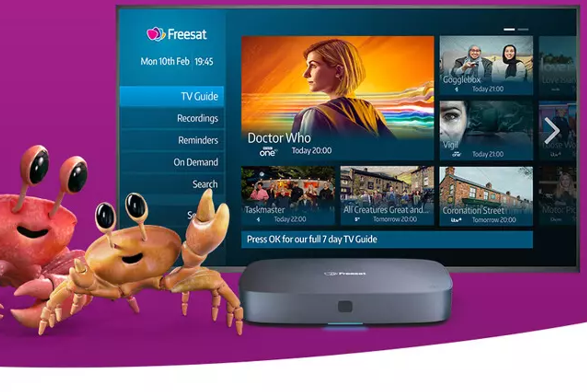 a promotional image for a freesat box with two cartoon crabs pointing at a flatscreen tv running the latest version of the freesat software 