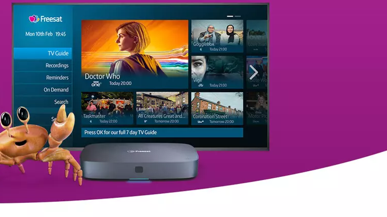 a promotional image for a freesat box with two cartoon crabs pointing at a flatscreen tv running the latest version of the freesat software