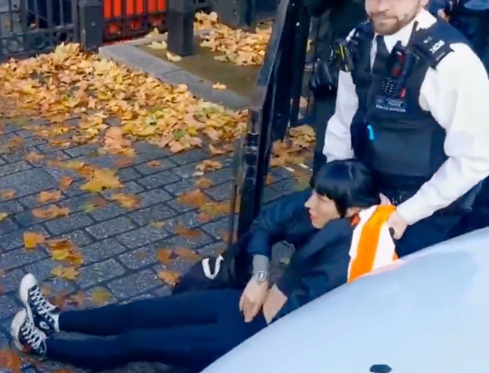 A protester being dragged away by police