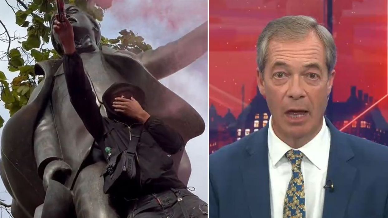 A protester holding aloft a red flare beside a statue dedicated to David Lloyd George (left) and Nigel Farage (right)