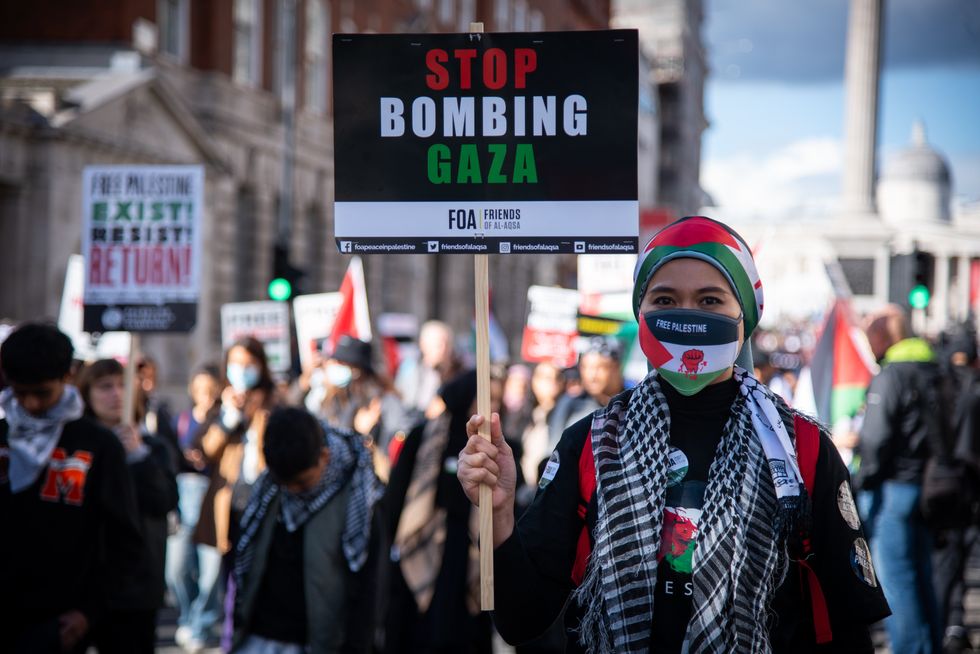 A protester holds a placard during the National Demonstration - March For Palestine