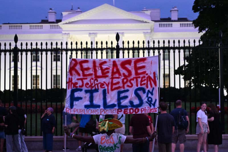 A protester holds a sign outside the White House demanding the release to all files related to Jeffrey Epstein