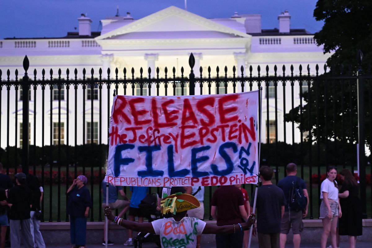 A protester holds a sign outside the White House demanding the release to all files related to Jeffrey Epstein