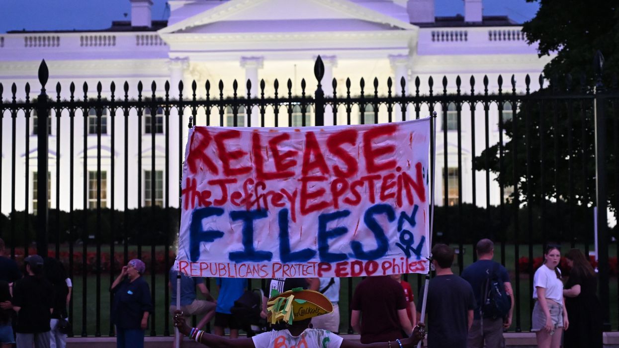 A protester holds a sign outside the White House demanding the release to all files related to Jeffrey Epstein