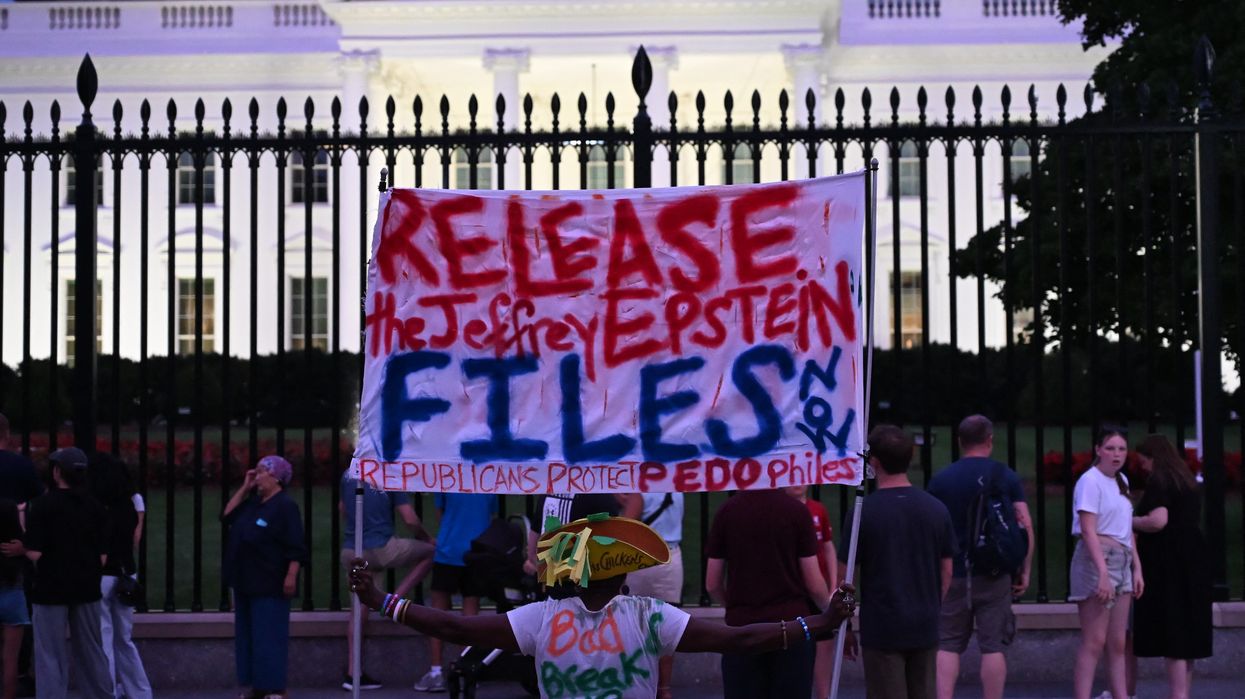 A protester holds a sign outside the White House demanding the release to all files related to Jeffrey Epstein