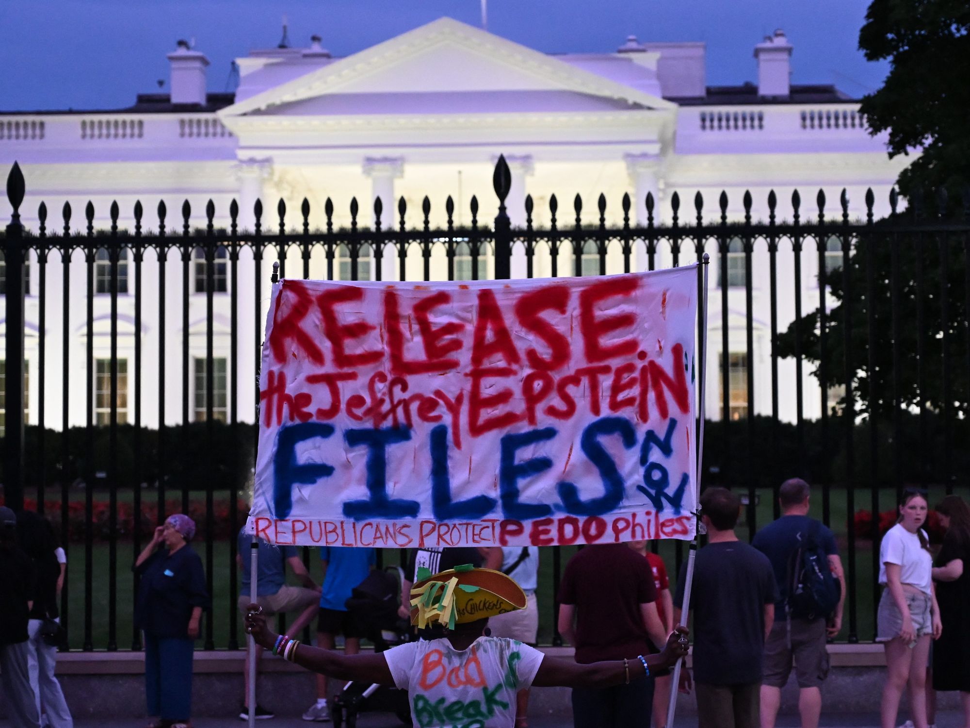 A protester holds a sign outside the White House demanding the release to all files related to Jeffrey Epstein