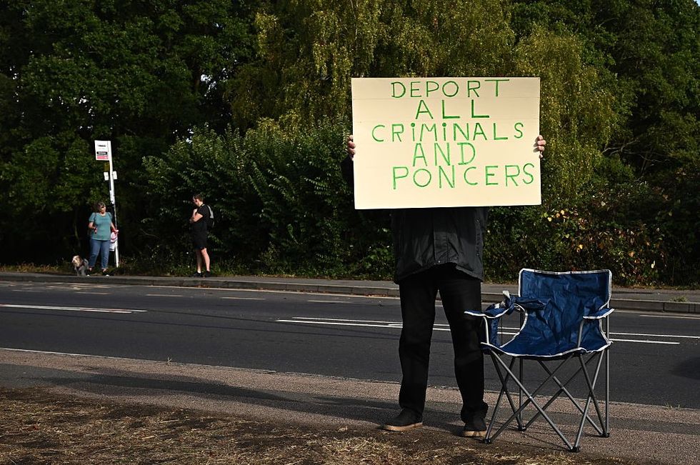 A protester holds a sign outside