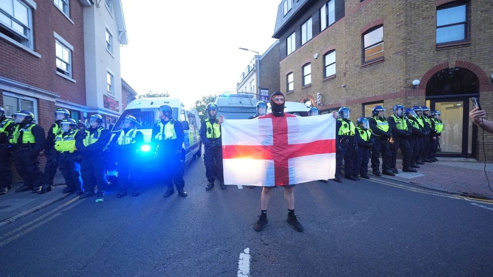A protester in front of police officers in Epping