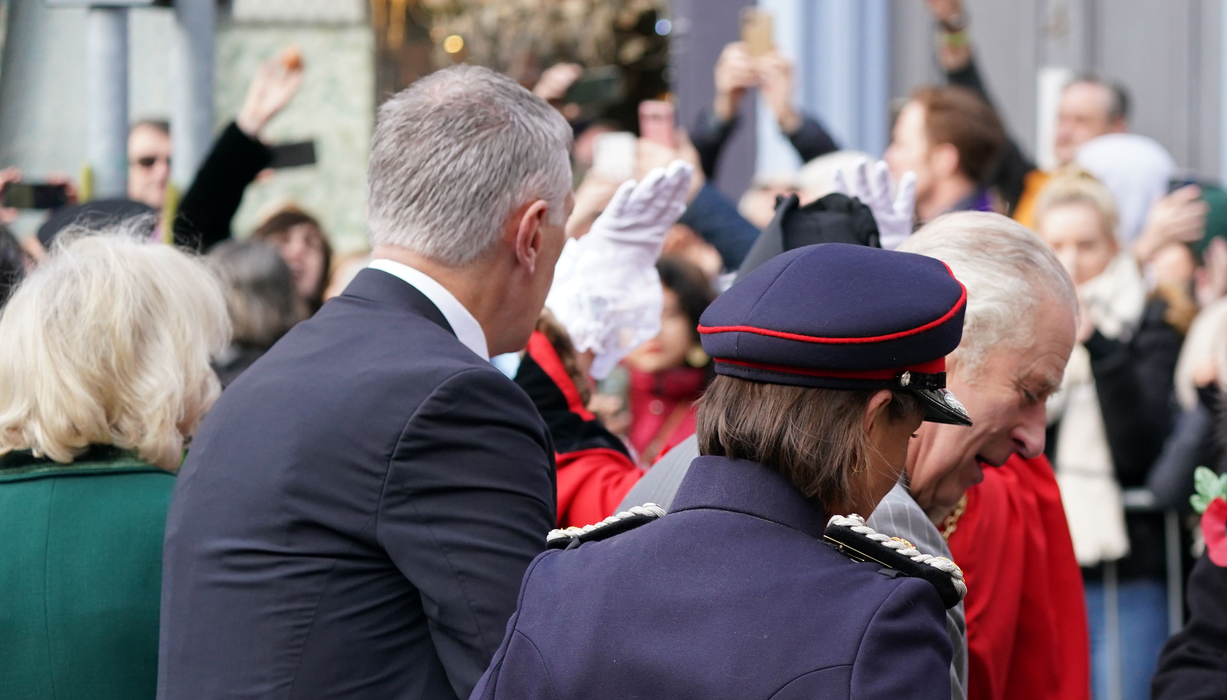 A protester (top left) is seen throwing an egg at the King.
