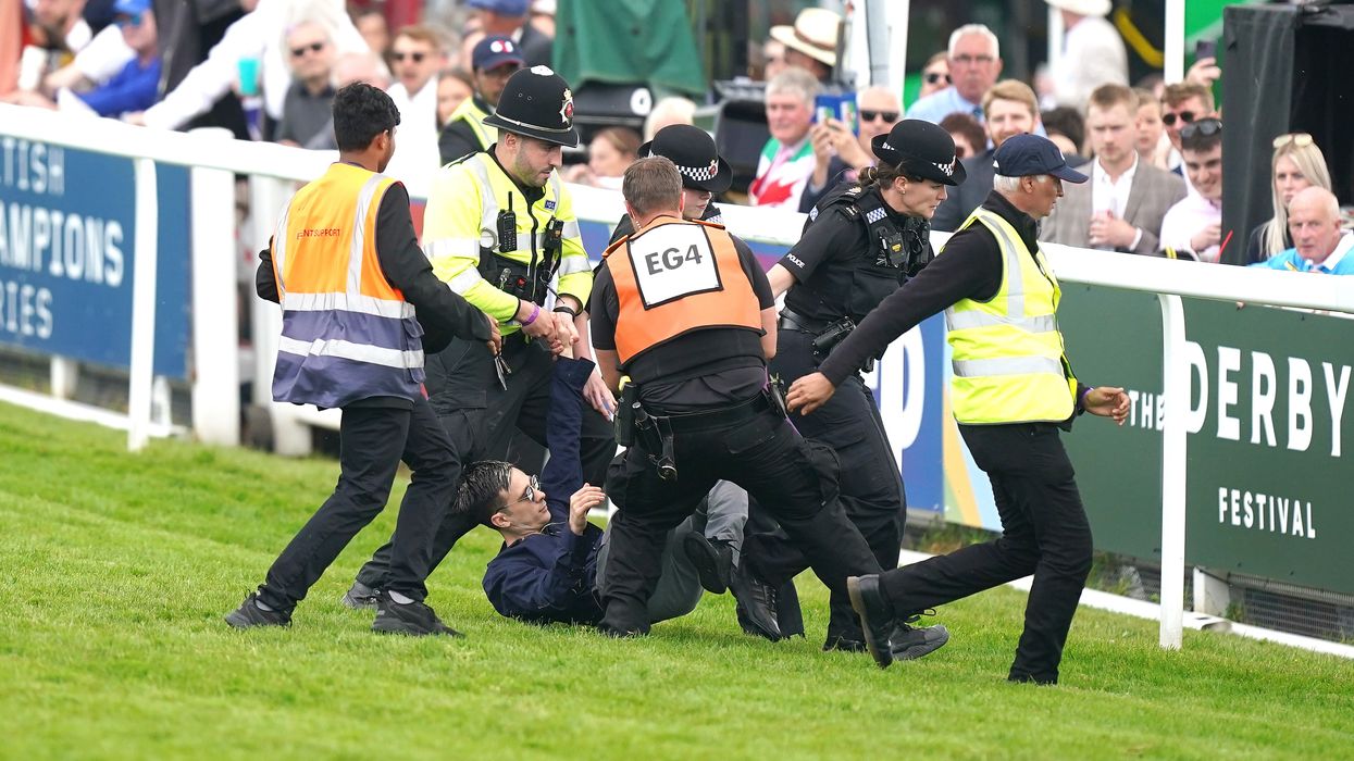 Epsom Derby: Protestor detained by police after running onto racecourse