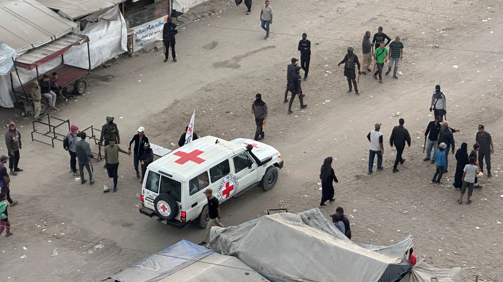 A Red Cross vehicle moves along a road before the expected release of hostages held in Gaza since the deadly October 7