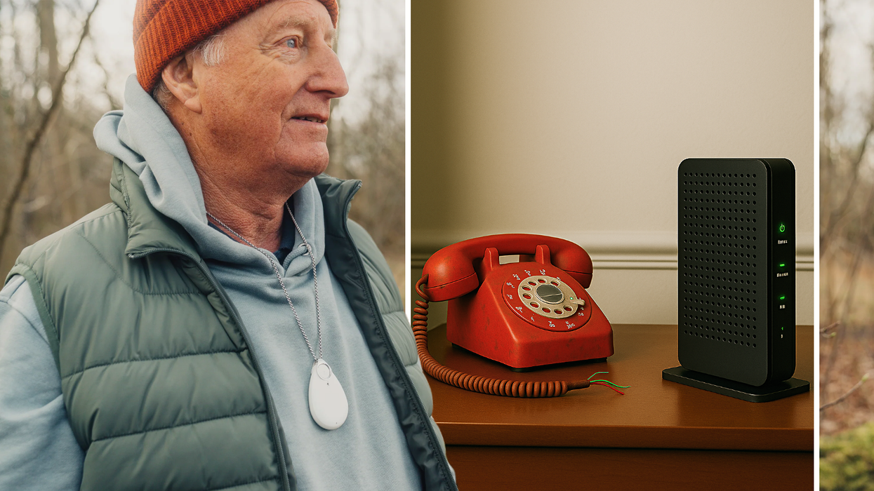 a red landline handset pictured on a wooden sidetable with the cables cut and a broadband router by its side