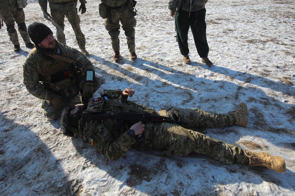 A retired foreign military professional conducts a military exercise for Ukrainian service members, amid Russia's attack on Ukraine, outside of Kharkiv, Ukraine February 10, 2023. REUTERS/Vyacheslav Madiyevskyy