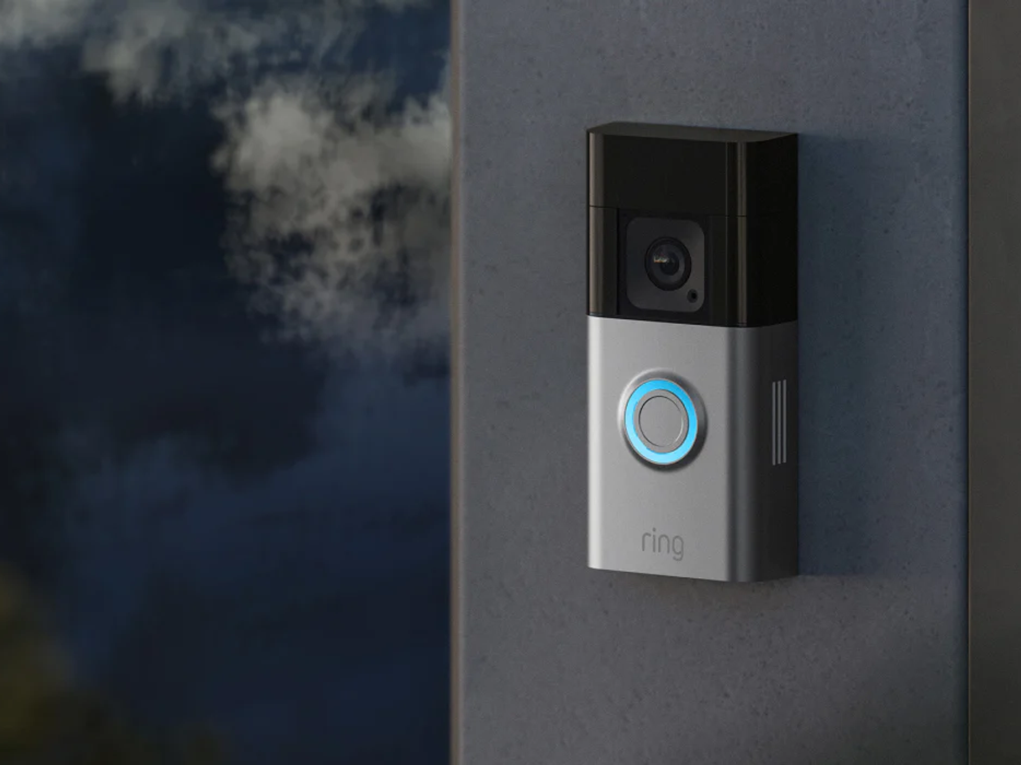 a ring video doorbell fitted to a metal frame around a door with the blue light illuminated
