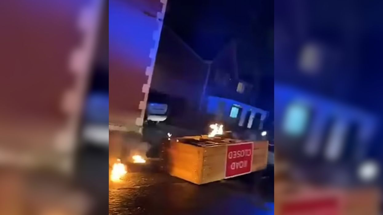 A road block is set on fire in Rochdale