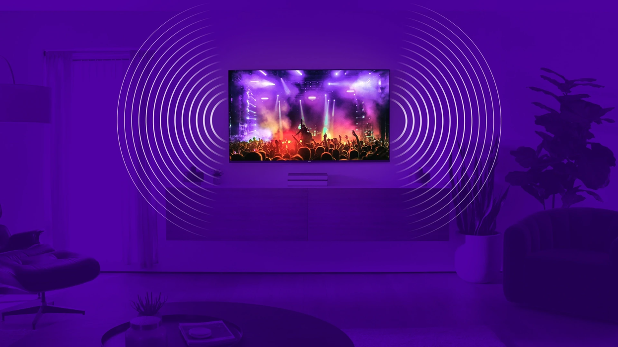 a roku pro series 4k tv is pictured on the wall with lines illustrating sound emitting from the sides of the panel