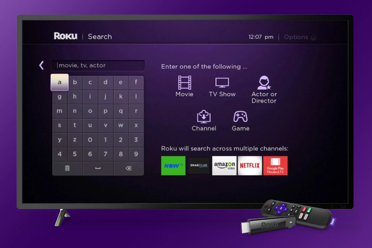 a roku stream stick and remote are pictured lying in front of a smart tv running the roku search menu 