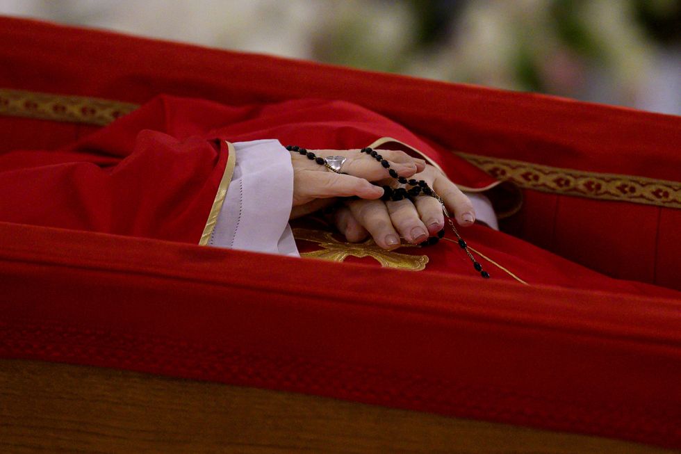 A rosary is seen as the body of Pope Francis is placed in an open casket during the rite of the declaration of death in Santa Marta residence at the Vatican