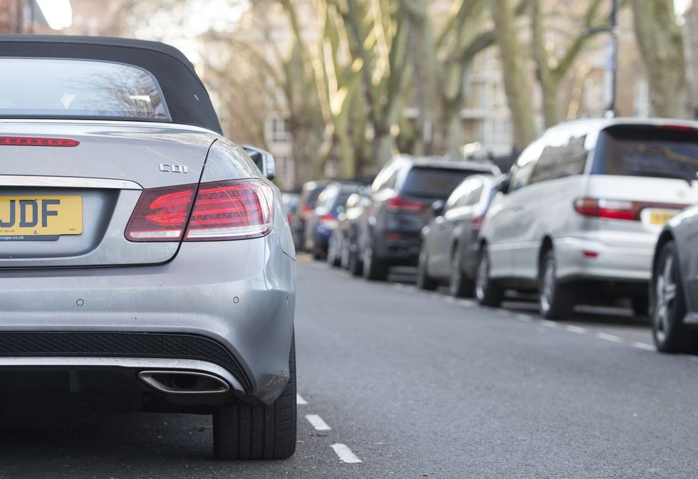 A row of cars parked on the road.