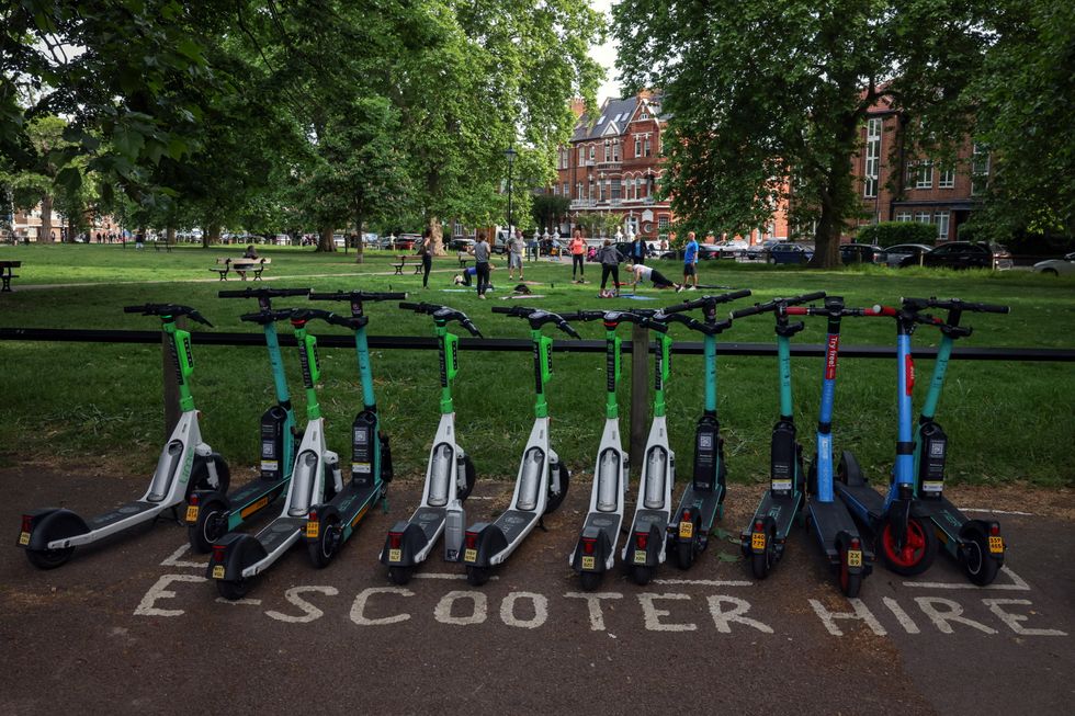 A row of e-scooters from Dott, Tier and Lime is seen on Parsons Green in London, Britain, May 18, 2022. REUTERS/Kevin Coombs