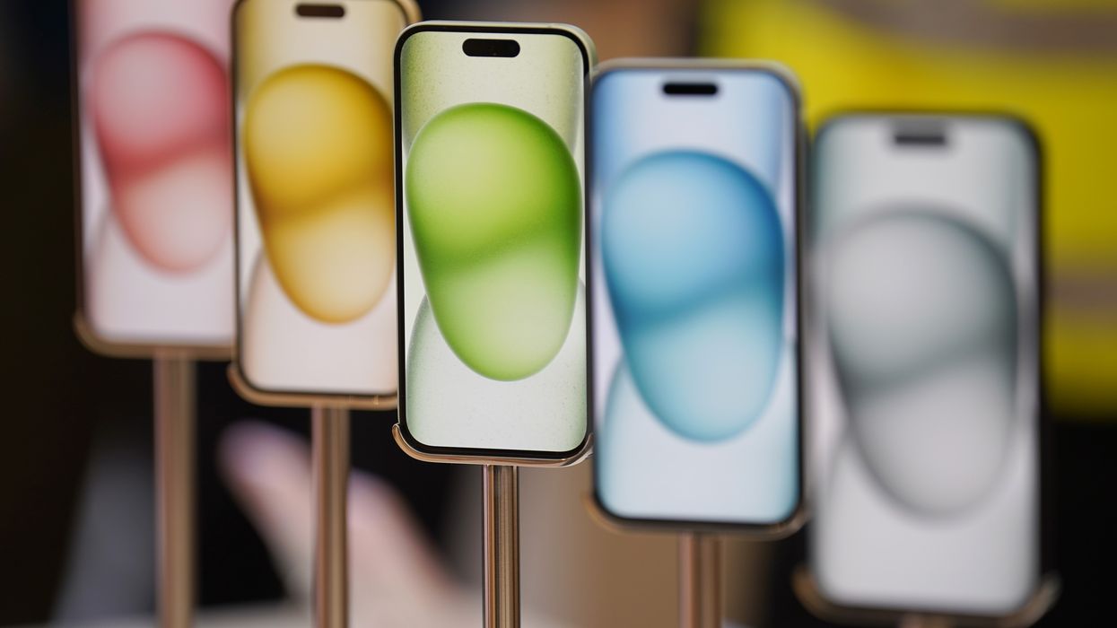 a row of iphone models in different colours in an apple store