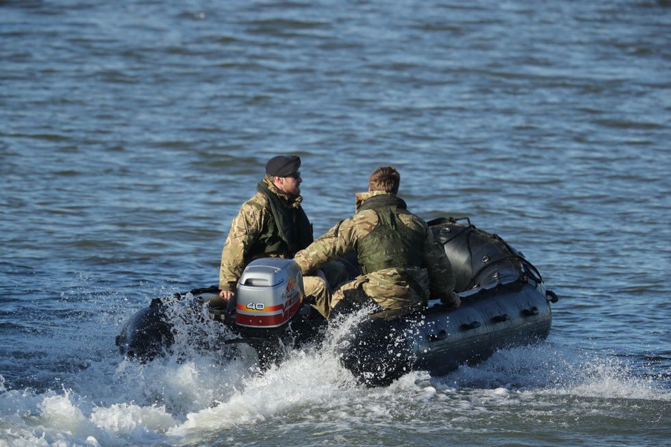 A Royal Navy bomb disposal team investigate George V Dock