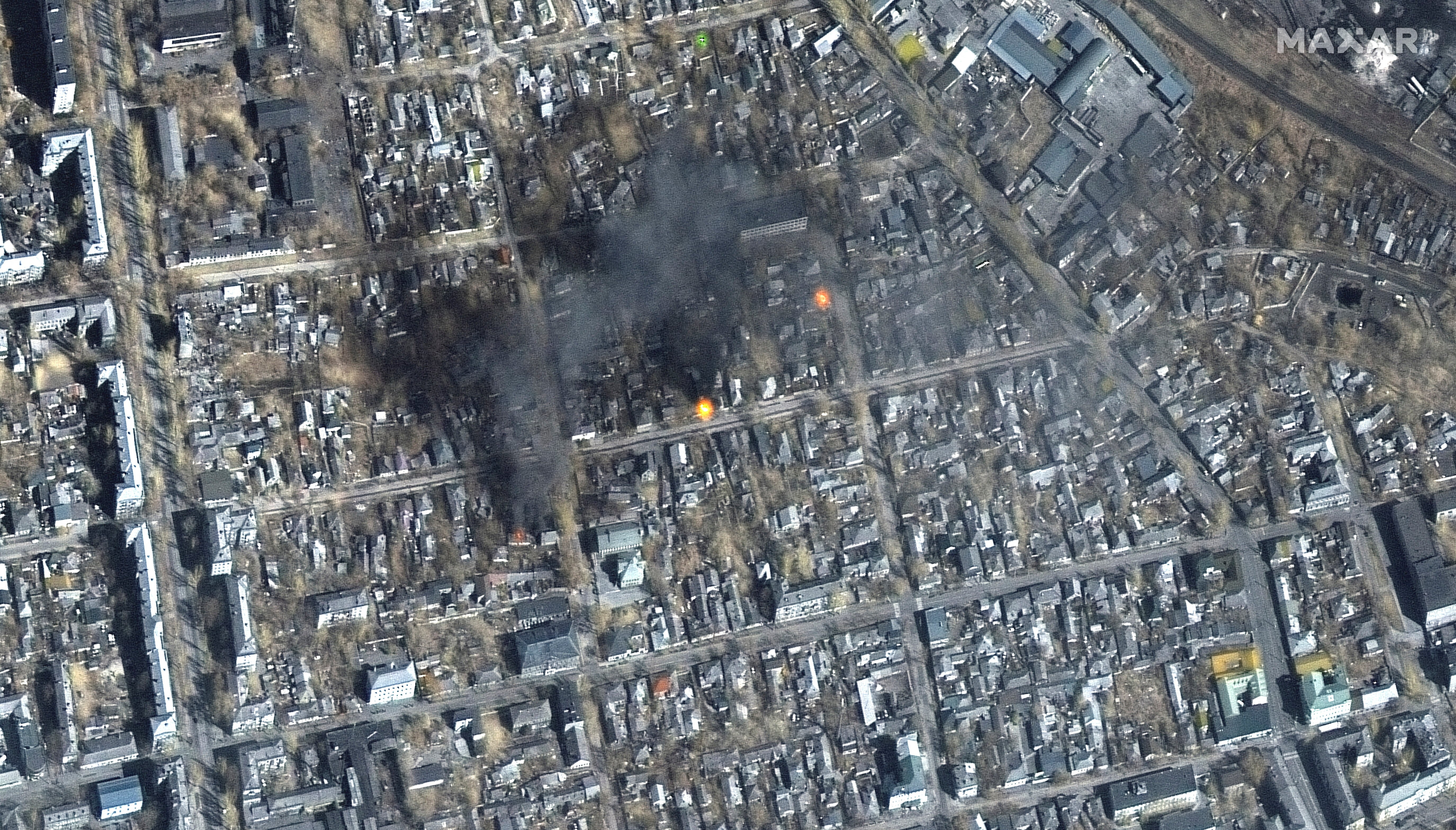 A satellite image shows a color infrared view of fires burning near Fontanna street, in eastern Mariupol.