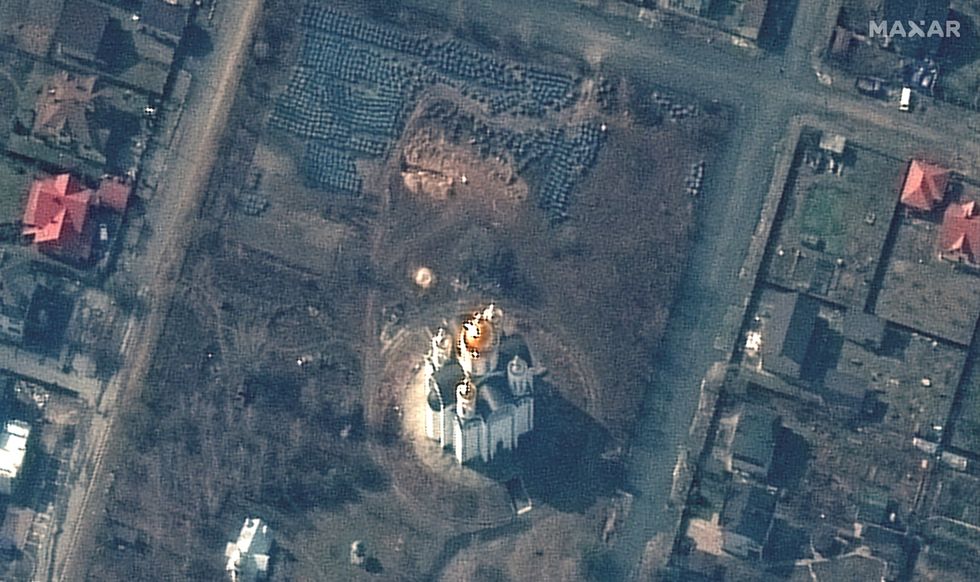 A satellite image shows the grave site with an approximately 45-foot (approximately 13,7 meters) long trench in the southwestern section of the area near the Church of St. Andrew and Pyervozvannoho All Saints, in Bucha, Ukraine, March 31, 2022. Picture taken March 31, 2022. Satellite image 2022 Maxar Technologies/Handout via REUTERS ATTENTION EDITORS - THIS IMAGE HAS BEEN SUPPLIED BY A THIRD PARTY. MANDATORY CREDIT. NO RESALES. NO ARCHIVES. DO NOT OBSCURE LOGO. TPX IMAGES OF THE DAY