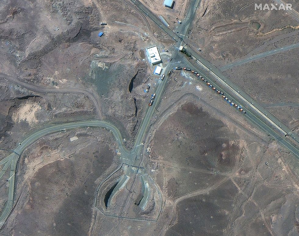 A satellite image shows trucks positioned near the entrance of the Fordow fuel enrichment facility, near Qom, Iran